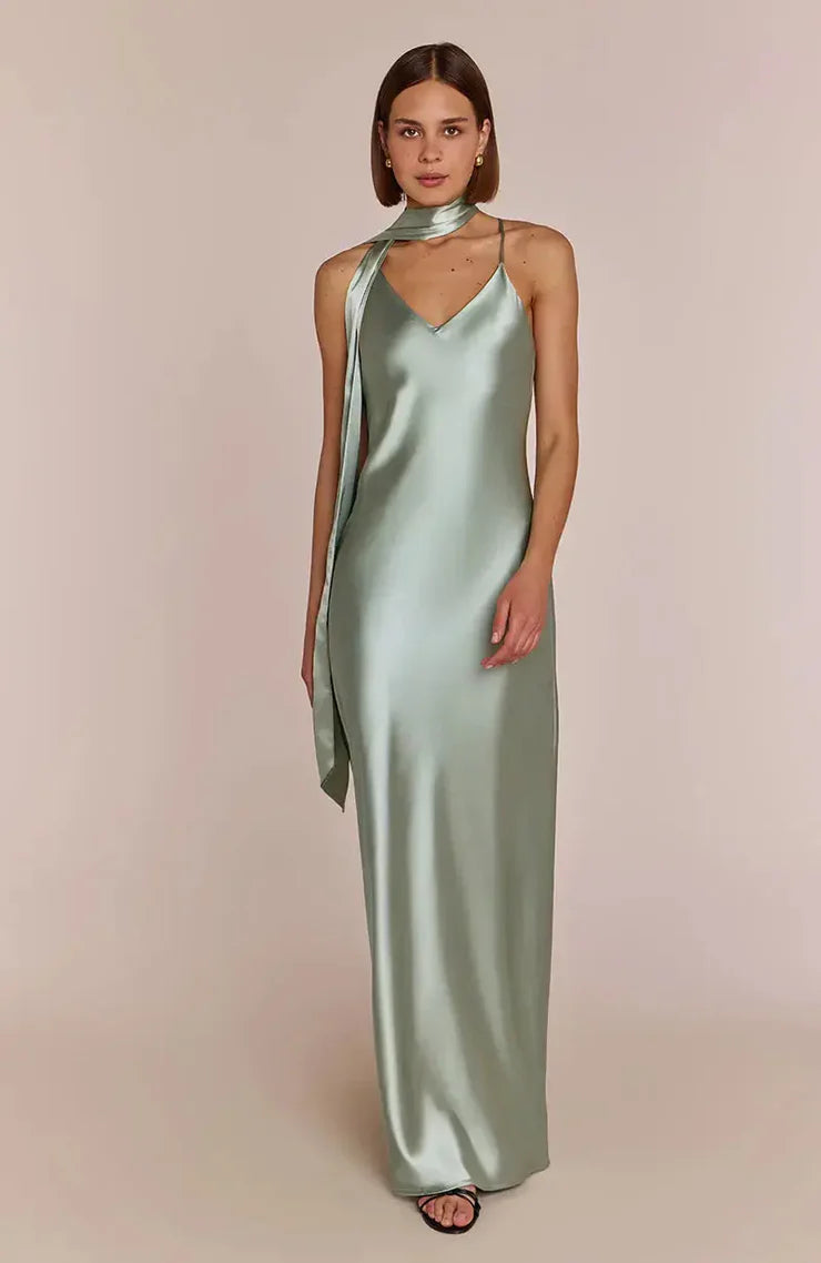 Woman wearing a REWRITTEN Brooklyn Bridesmaid Dress in Sage Green against a plain background