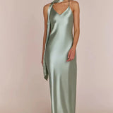 Woman wearing a REWRITTEN Brooklyn Bridesmaid Dress in Sage Green against a plain background