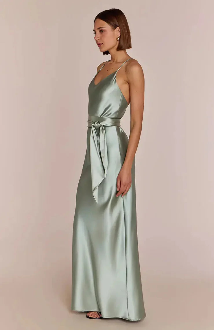 Right side-pose Woman wearing a REWRITTEN Brooklyn Bridesmaid Dress in Sage Green against a plain background
