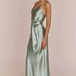 Right side-pose Woman wearing a REWRITTEN Brooklyn Bridesmaid Dress in Sage Green against a plain background