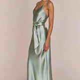 Right side-pose Woman wearing a REWRITTEN Brooklyn Bridesmaid Dress in Sage Green against a plain background
