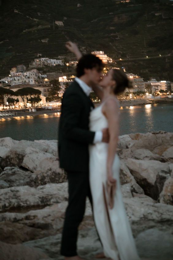Bride and bridesmaids in elegant wedding dresses posing in an Italian villa setting - destination wedding dress rental UK
