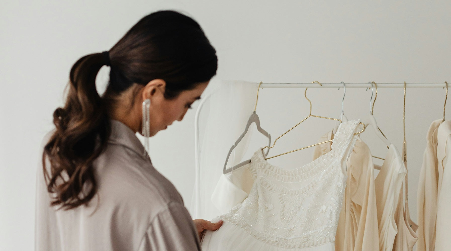 Bride trying on rental dresses at home, as offered by the Something Borrowed Home Try-On offer