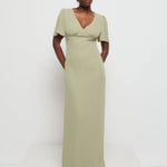 Model in Flattering V-neckline Edie Chiffon Maxi bridesmaid dress in olive green,  under Bust detailing with floaty cap sleeves against a white background