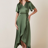 A woman standing and posing in an olive green, V-neck, short-sleeved, midi-length bridesmaid dress with a waterfall hem.