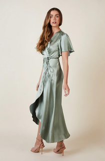 Model wearing a sage green satin midi bridesmaid dress with draped short sleeves and tie-back detail, available for hire from Something Borrowed Rent.