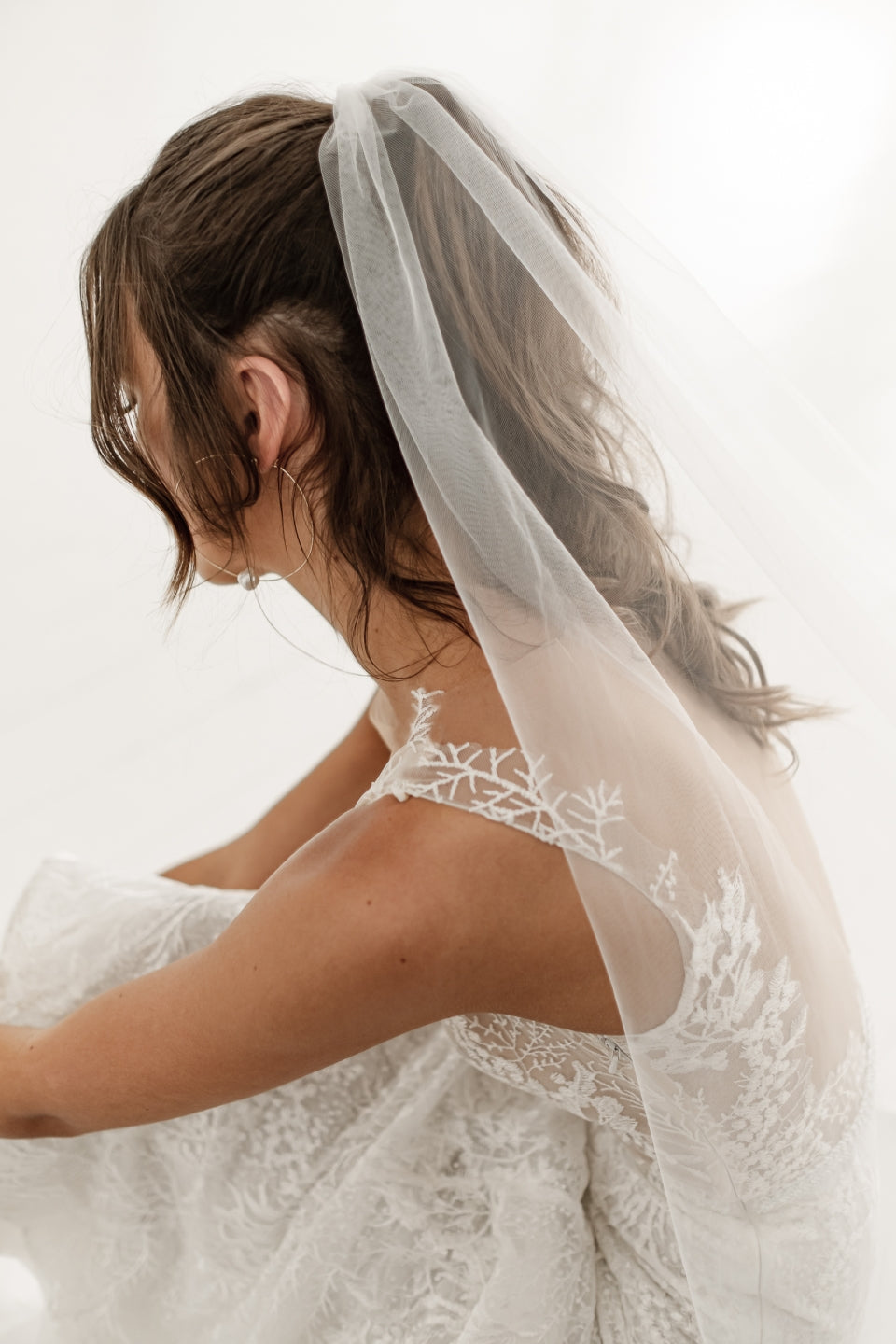 OUI The Label One Tier Veil in natural white, worn at the back of the head