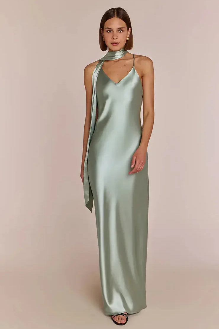 Woman wearing a REWRITTEN Brooklyn Bridesmaid Dress in Sage Green against a plain background